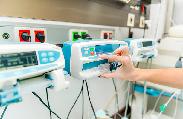 Intensive care inffusion pump adjusted by a nurse hand